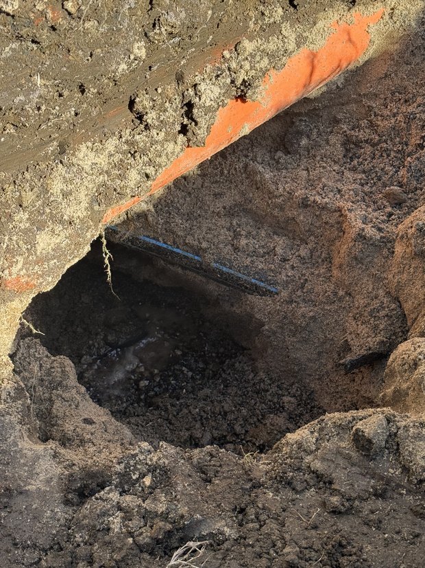 Leaking pipe located and exposed in the trench