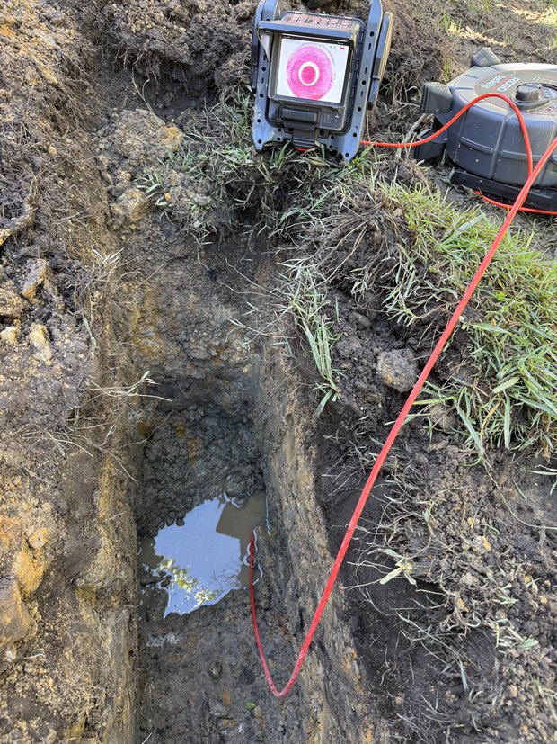 Pipe camera and locator used in an open trench