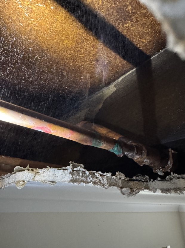 Corroded copper pipe located in the subfloor