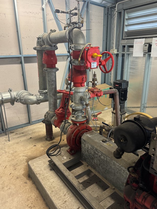 Commercial pump and valve room during a leak investigation