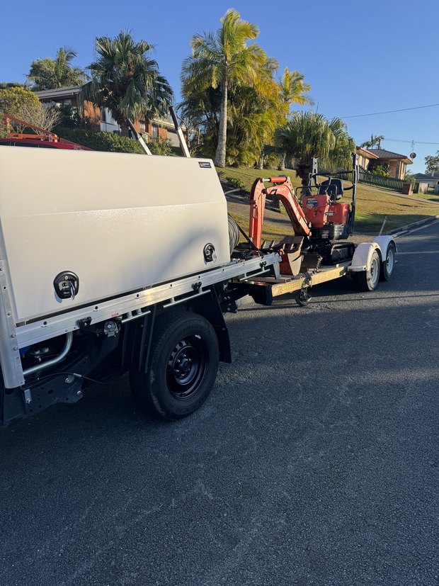 Got A Leak ute towing the mini excavator