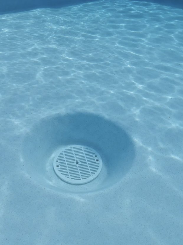 Hydrostatic valve and bottom drain plug in a pool floor