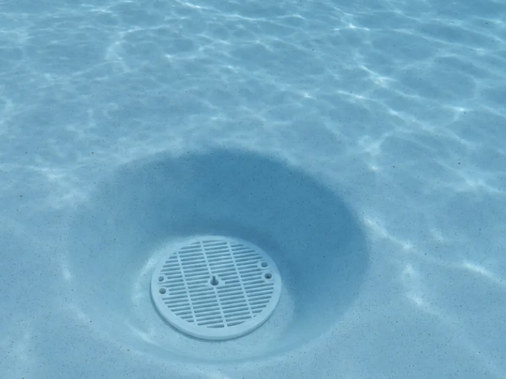 Hydrostatic valve and bottom drain plug in a pool floor