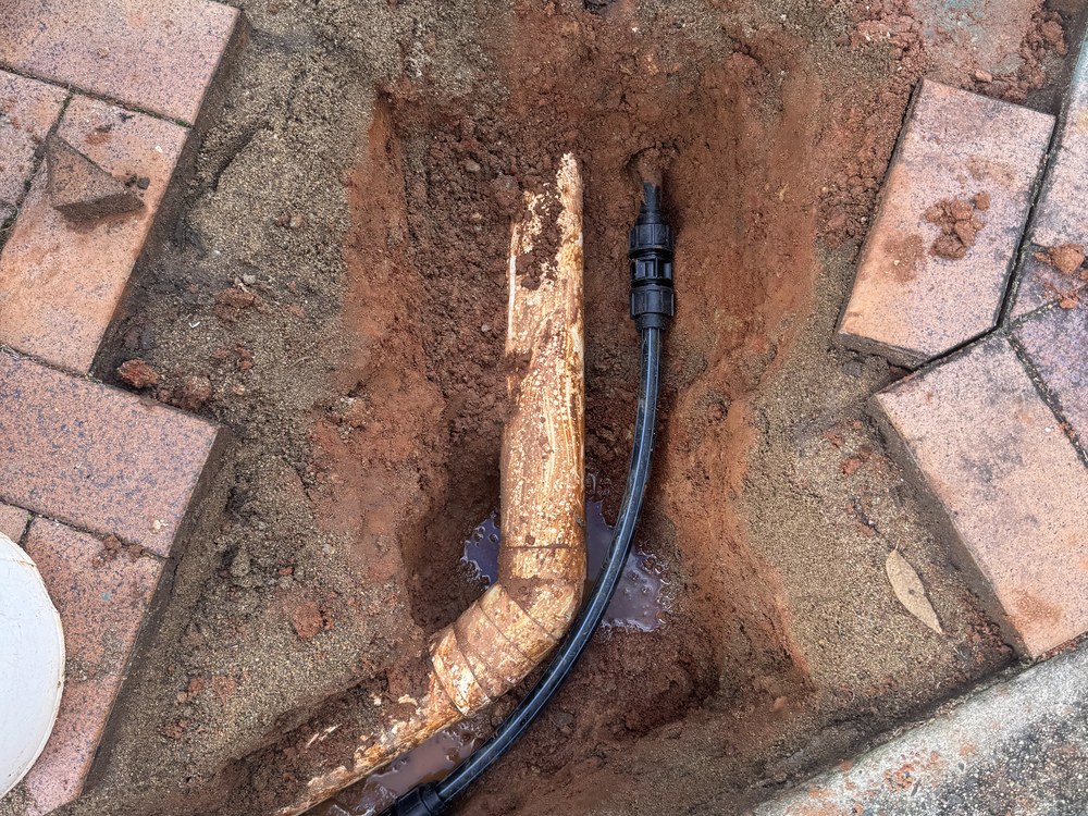 Burst pipe cut out and replaced with new poly under pavers