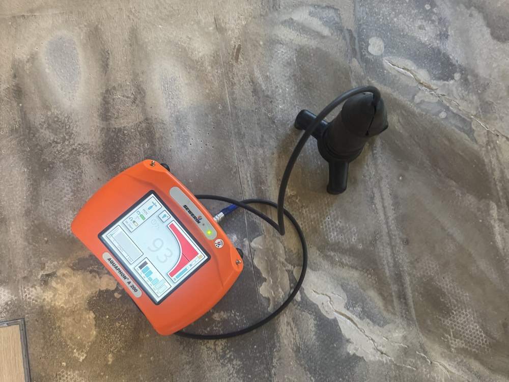 Acoustic leak detection equipment locating a leak under a concrete slab