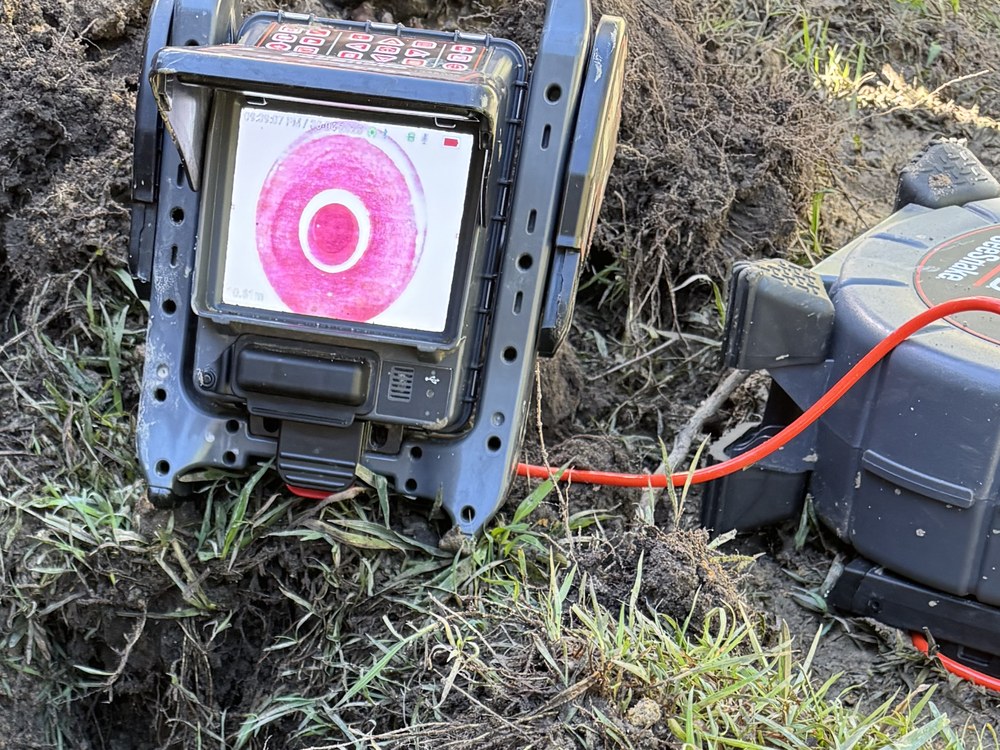 Pipe locator and trace reel in use finding an underground water service